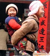 Ethnic minorities still carry their babies on their backs as they have done for generations