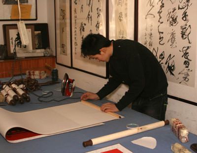 Preparing to install the top frame of the wall scroll